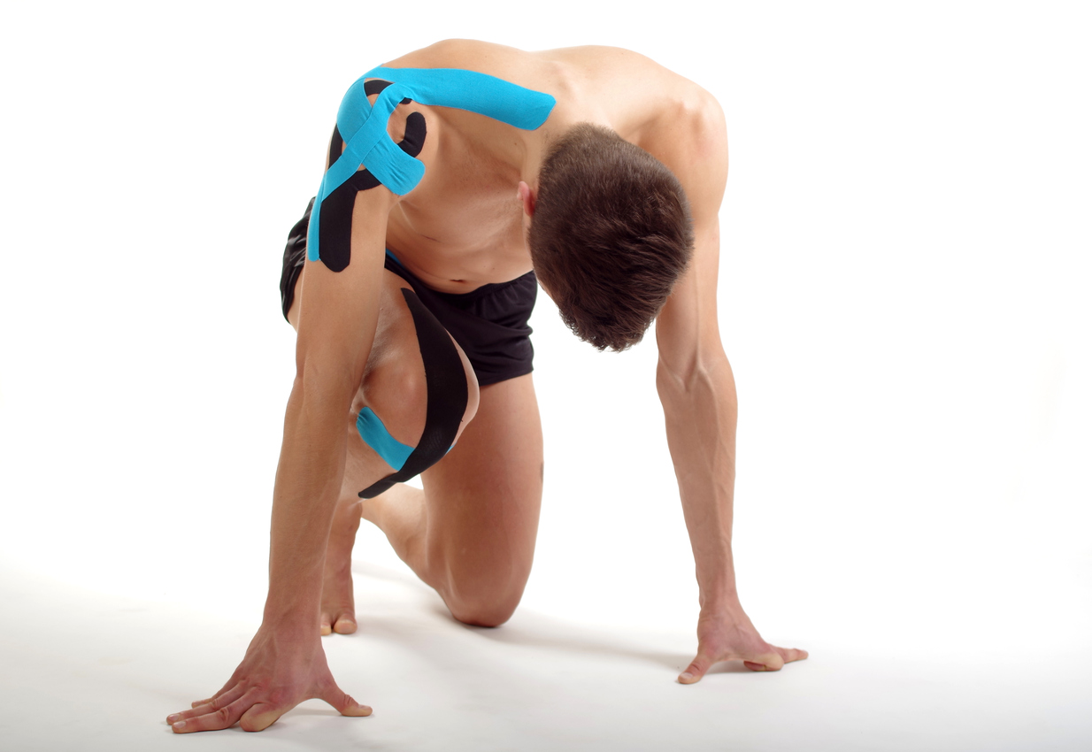Starting position man, kinesiology tape physiotherapy for shoulder and knee